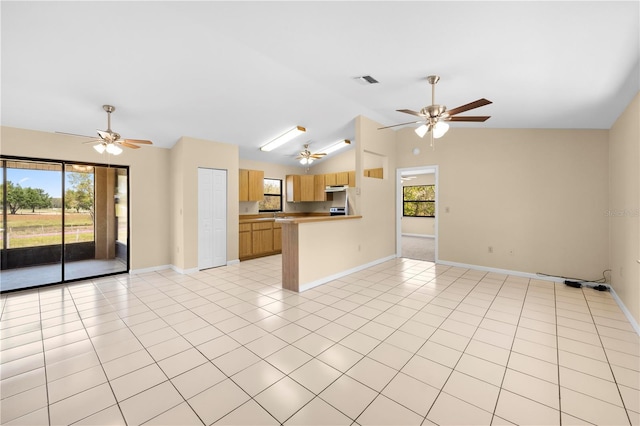 kitchen featuring ceiling fan, a healthy amount of sunlight, open floor plan, and light tile patterned floors