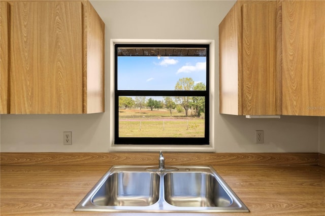 kitchen featuring modern cabinets, light countertops, and a sink