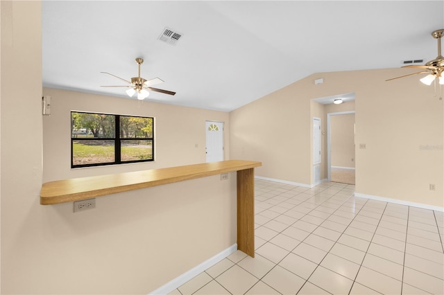 kitchen with light tile patterned floors, visible vents, a ceiling fan, and vaulted ceiling