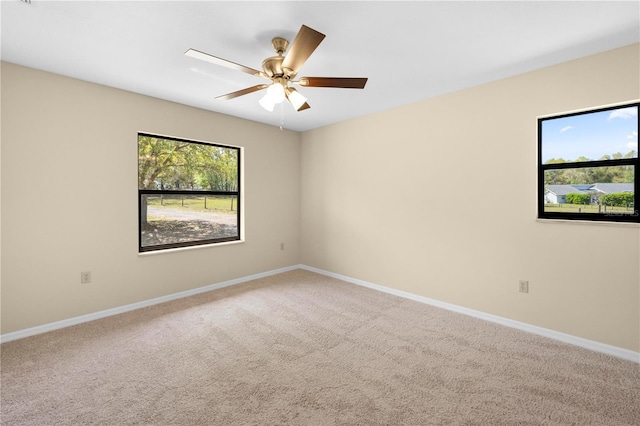 unfurnished room with baseboards, carpet floors, and ceiling fan