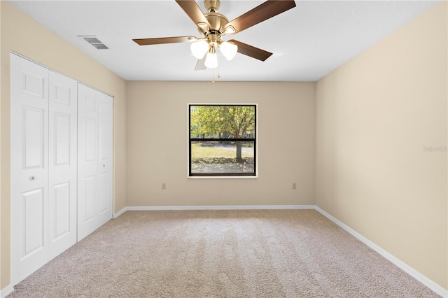 unfurnished bedroom featuring carpet flooring, baseboards, visible vents, and a closet