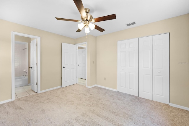 unfurnished bedroom with carpet flooring, baseboards, visible vents, and a closet