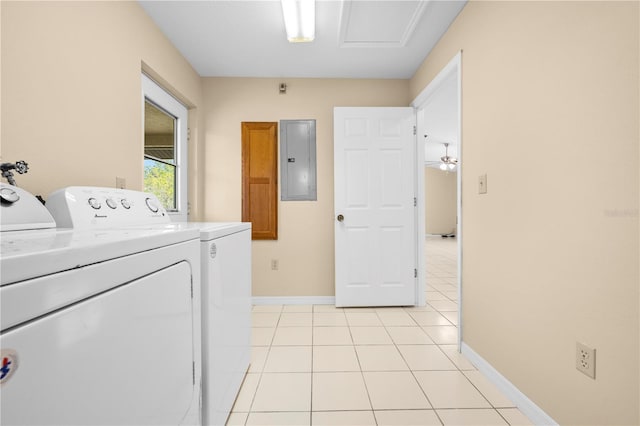 laundry room featuring light tile patterned floors, baseboards, washing machine and clothes dryer, laundry area, and electric panel