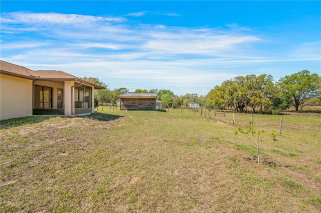 view of yard featuring a sunroom and fence