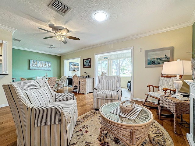 living room with visible vents and ornamental molding