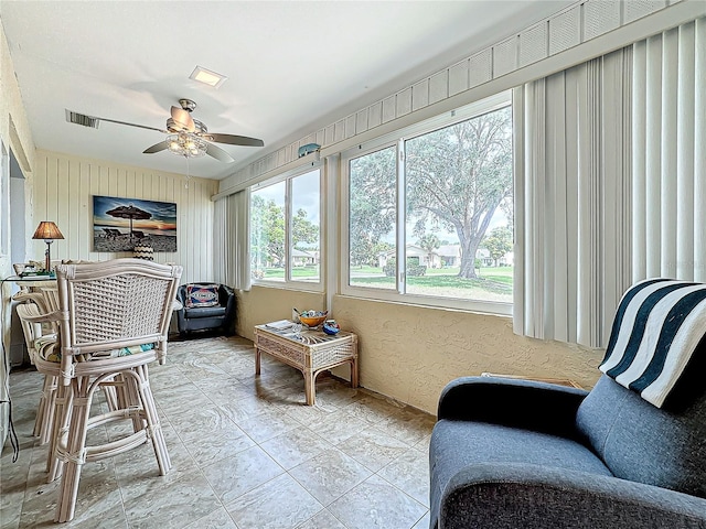 sunroom / solarium with visible vents and ceiling fan