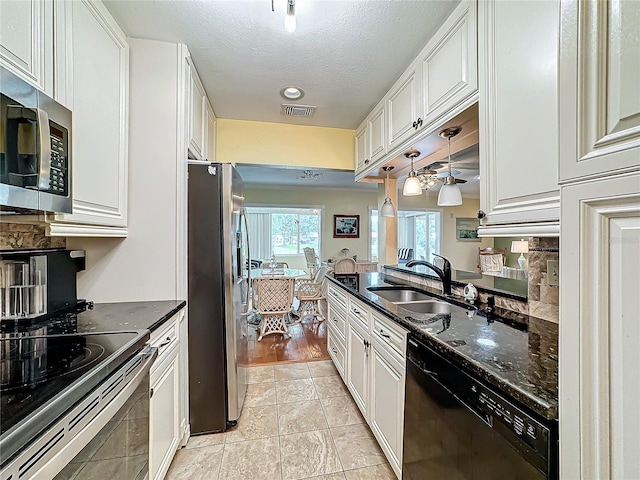 kitchen featuring visible vents, white cabinets, appliances with stainless steel finishes, and a sink