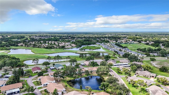 drone / aerial view with a residential view, a water view, and view of golf course