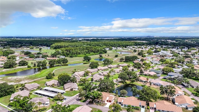 birds eye view of property featuring a residential view, a water view, and view of golf course