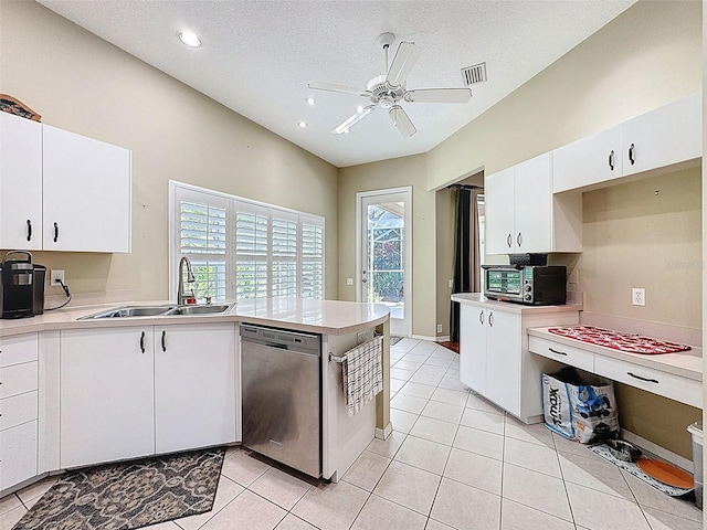 kitchen featuring visible vents, dishwasher, light countertops, a peninsula, and a sink