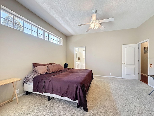 carpeted bedroom with connected bathroom, a textured ceiling, baseboards, and a ceiling fan