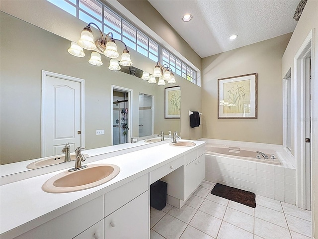 full bath with a sink, a chandelier, and a bath