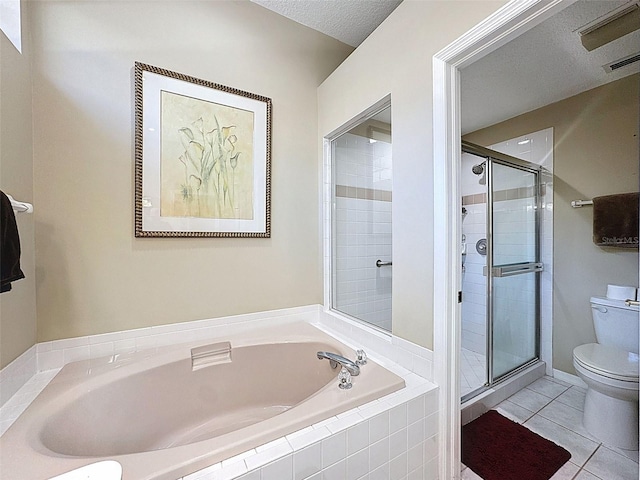 bathroom featuring tile patterned flooring, a shower stall, toilet, and a bath