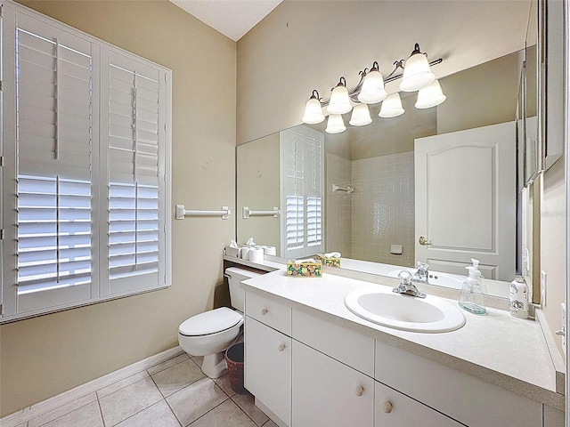 bathroom with baseboards, toilet, vanity, and tile patterned flooring