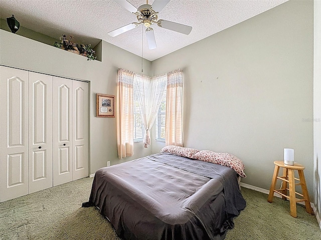 bedroom with a closet, a textured ceiling, baseboards, and carpet floors