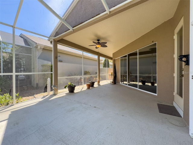 unfurnished sunroom featuring ceiling fan and a skylight