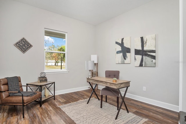 office space featuring baseboards and dark wood finished floors