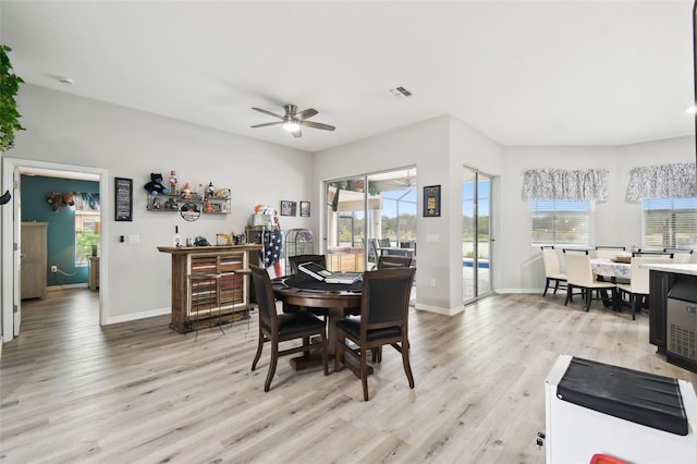 dining space featuring a wealth of natural light, baseboards, visible vents, and light wood finished floors