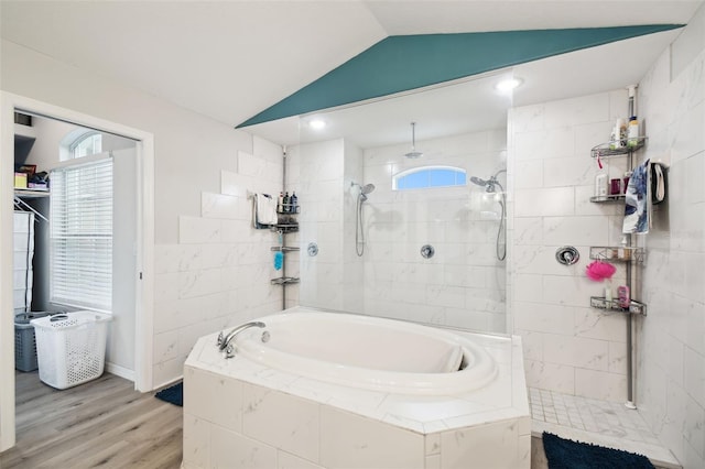 full bath featuring a bath, a walk in shower, wood finished floors, and vaulted ceiling