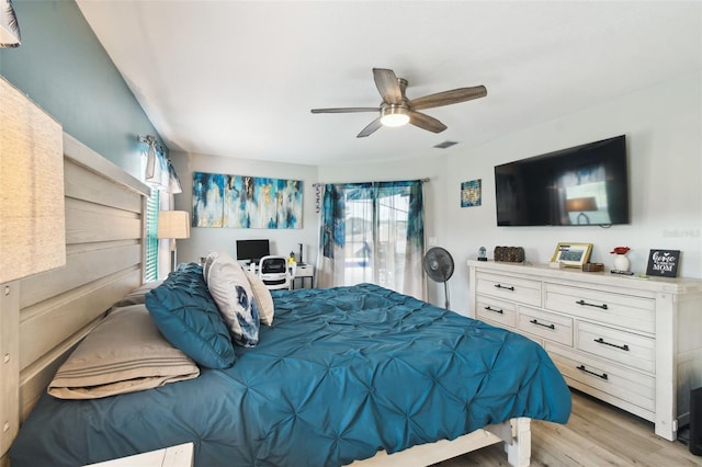 bedroom with visible vents, light wood-type flooring, and a ceiling fan