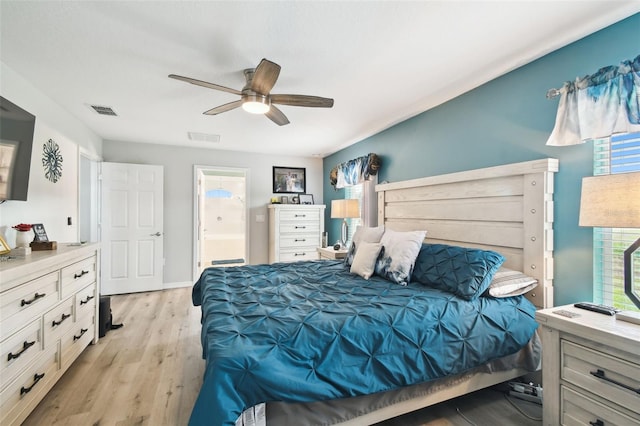 bedroom featuring ensuite bath, light wood-style floors, visible vents, and ceiling fan