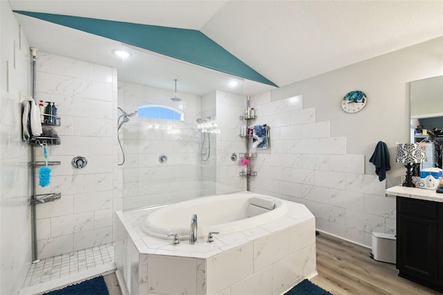 full bath featuring vanity, wood finished floors, lofted ceiling, a walk in shower, and a bath