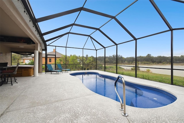 pool featuring a patio area and glass enclosure