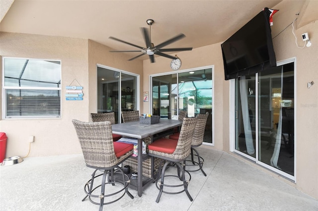 view of patio with outdoor dining area and ceiling fan