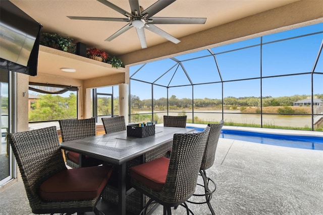 view of patio featuring a lanai, outdoor dining space, an outdoor pool, and ceiling fan