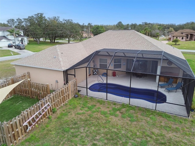 exterior space with glass enclosure, a patio, a lawn, and fence private yard