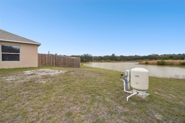 view of yard with fence and a water view