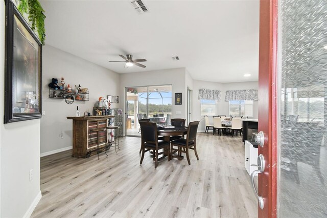 18317 Treehaven Dr, Hudson, FL 34667 - dining room with baseboards, light wood-style flooring, and ceiling fan