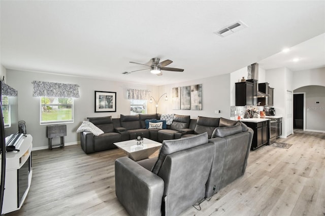 18317 Treehaven Dr, Hudson, FL 34667 - living area featuring ceiling fan, arched walkways, light wood-type flooring, baseboards, and recessed lighting