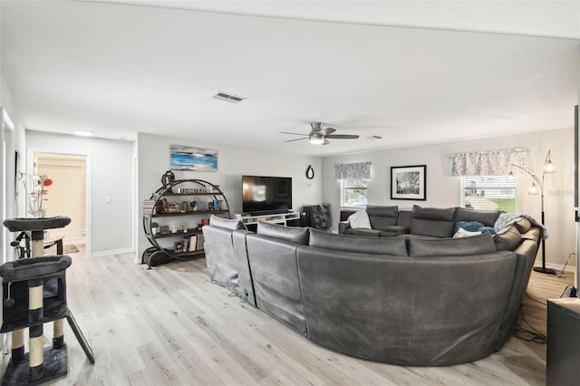 18317 Treehaven Dr, Hudson, FL 34667 - living area with light wood-style flooring, a ceiling fan, and baseboards