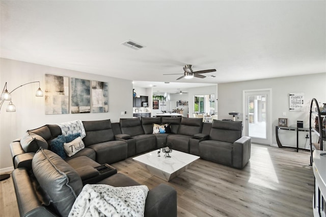18317 Treehaven Dr, Hudson, FL 34667 - living room with a ceiling fan, light wood-type flooring, and baseboards