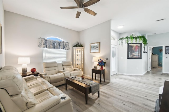 18317 Treehaven Dr, Hudson, FL 34667 - living room with light wood-style floors, a ceiling fan, and baseboards