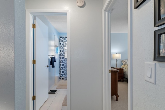 hall featuring light tile patterned floors