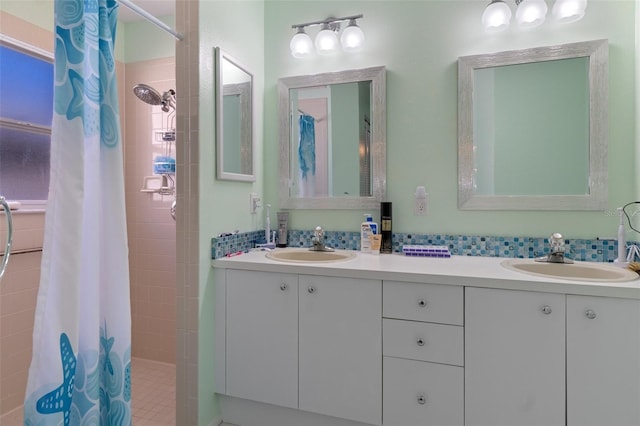 bathroom featuring a sink, double vanity, and a tile shower