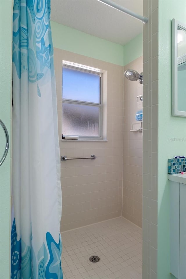 full bathroom with tiled shower