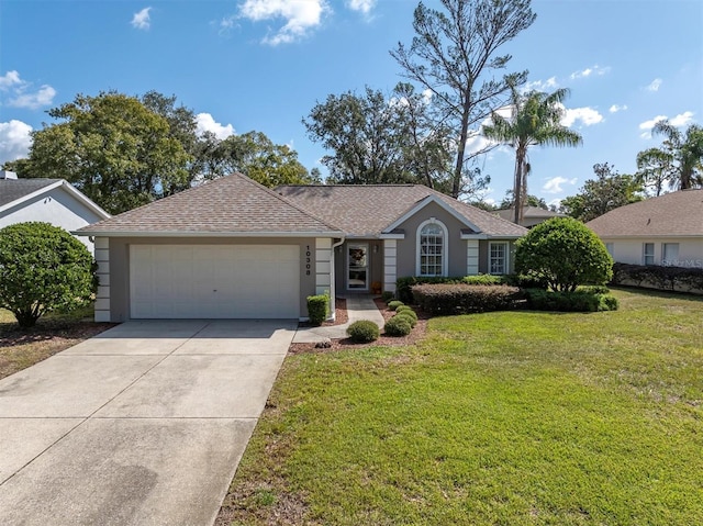 ranch-style home featuring a front lawn, an attached garage, concrete driveway, and a shingled roof