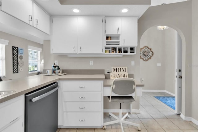 kitchen featuring light tile patterned flooring, white cabinetry, light countertops, and stainless steel dishwasher