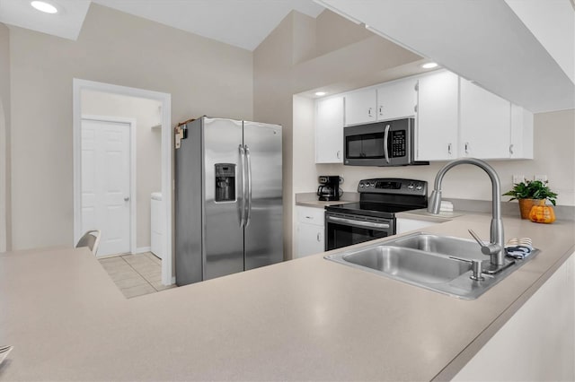 kitchen featuring light countertops, recessed lighting, appliances with stainless steel finishes, white cabinets, and a sink