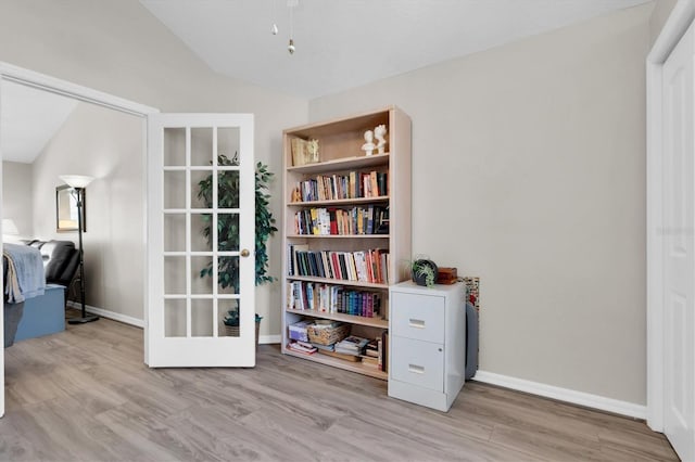 sitting room with vaulted ceiling, baseboards, and wood finished floors