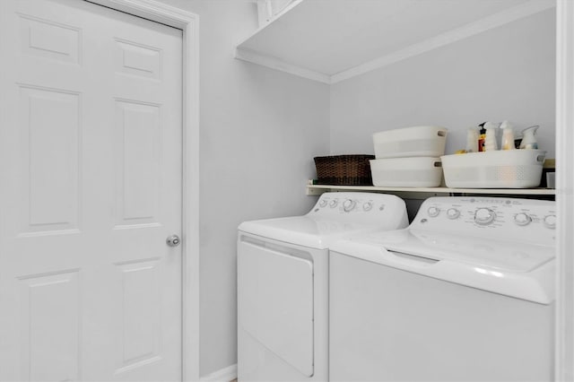 washroom with washer and dryer, ornamental molding, and laundry area