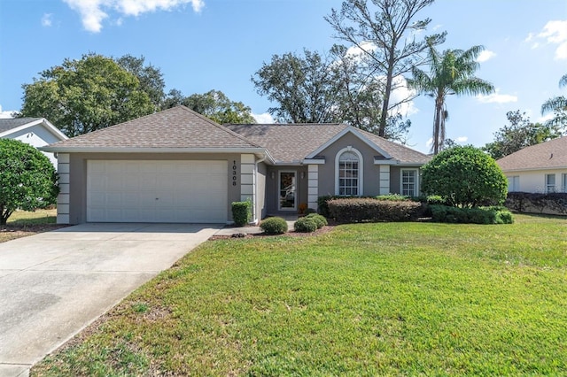 ranch-style home featuring a shingled roof, concrete driveway, a front yard, stucco siding, and a garage