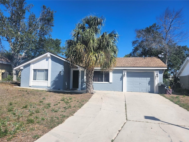 view of front of property featuring driveway, stucco siding, and an attached garage