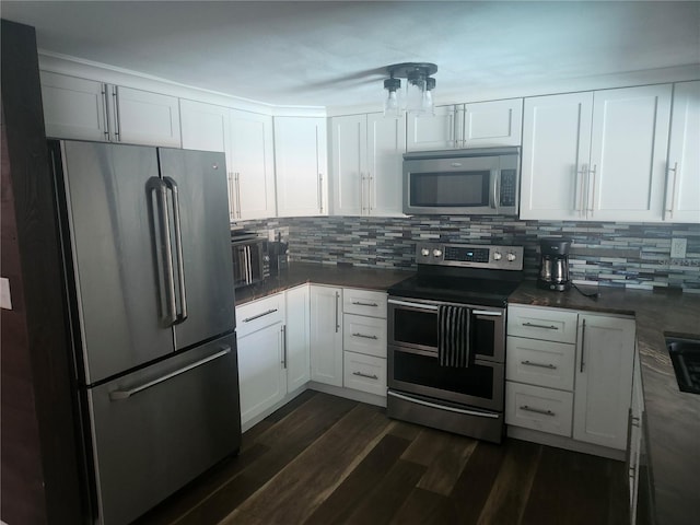 kitchen with white cabinetry, tasteful backsplash, appliances with stainless steel finishes, and dark wood finished floors