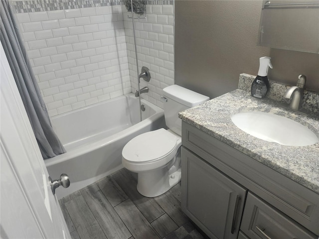 full bathroom with wood finished floors, toilet, vanity, and shower / bath combo