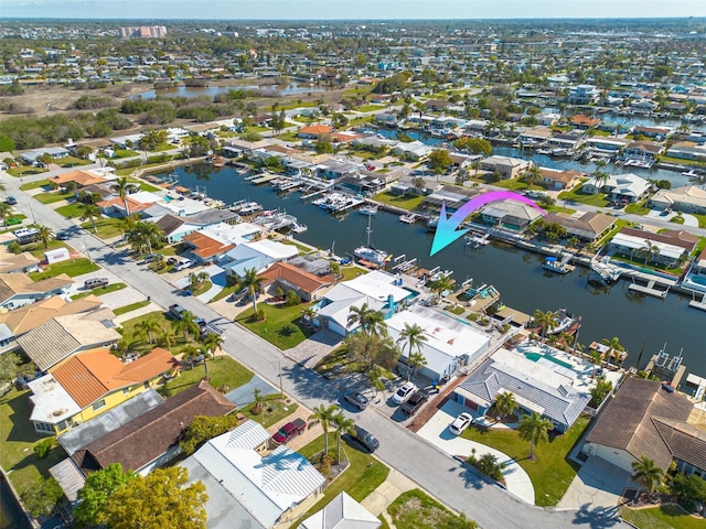 bird's eye view featuring a residential view and a water view