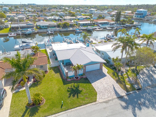 birds eye view of property with a residential view and a water view